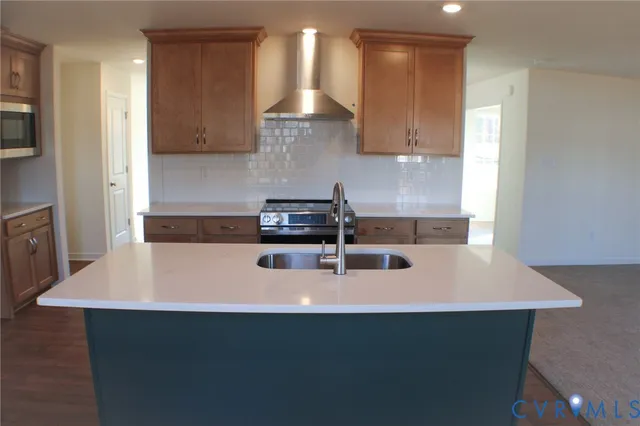 a kitchen with stainless steel appliances a sink a stove and a refrigerator