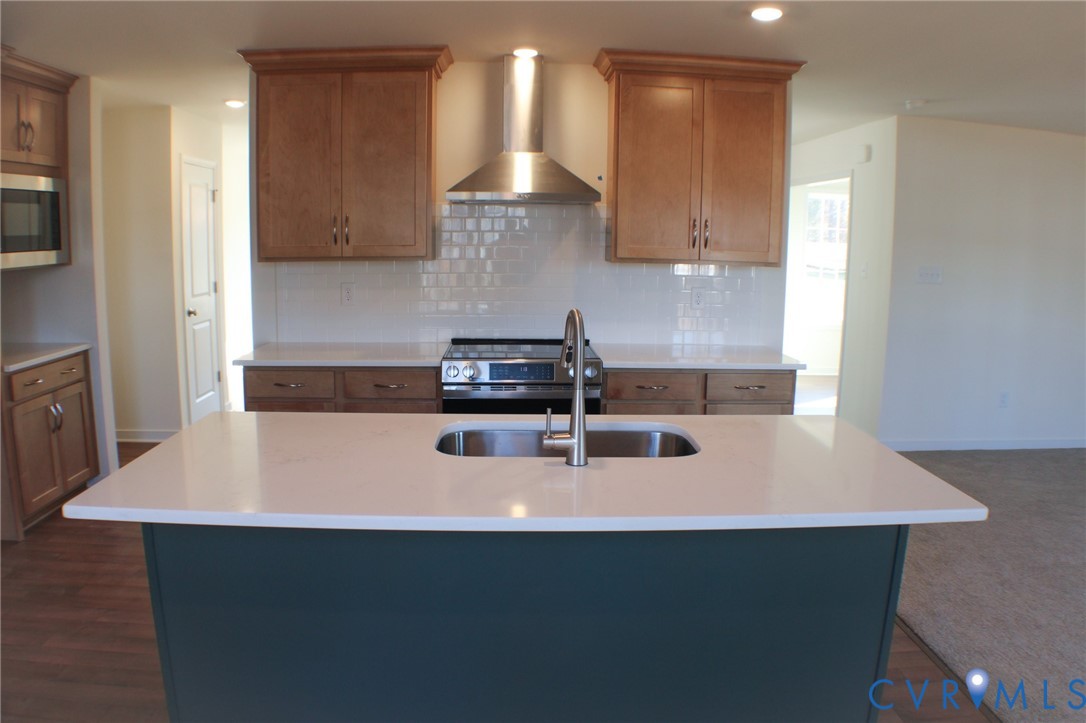 8249 Reedy Knl Drive Richmond, VA 23237 - Photo 4 of 11 a kitchen with stainless steel appliances a sink a stove and a refrigerator