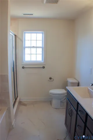 a bathroom with a toilet a sink and a window