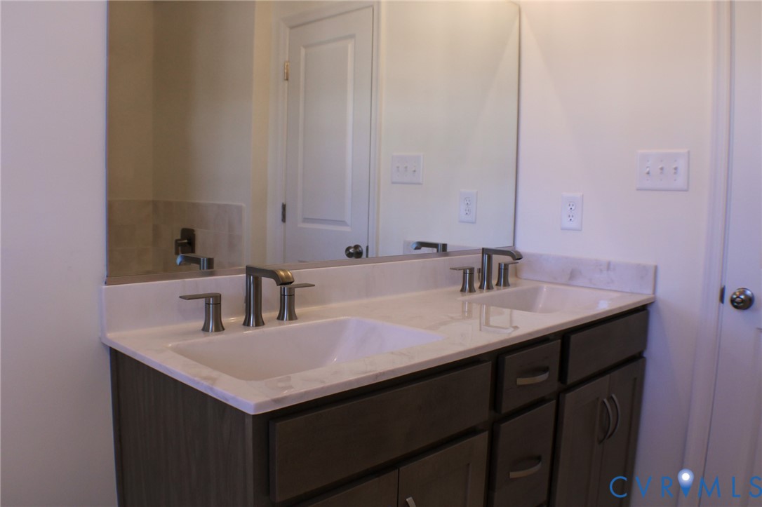 8249 Reedy Knl Drive Richmond, VA 23237 - Photo 9 of 11 a bathroom with a sink and a mirror