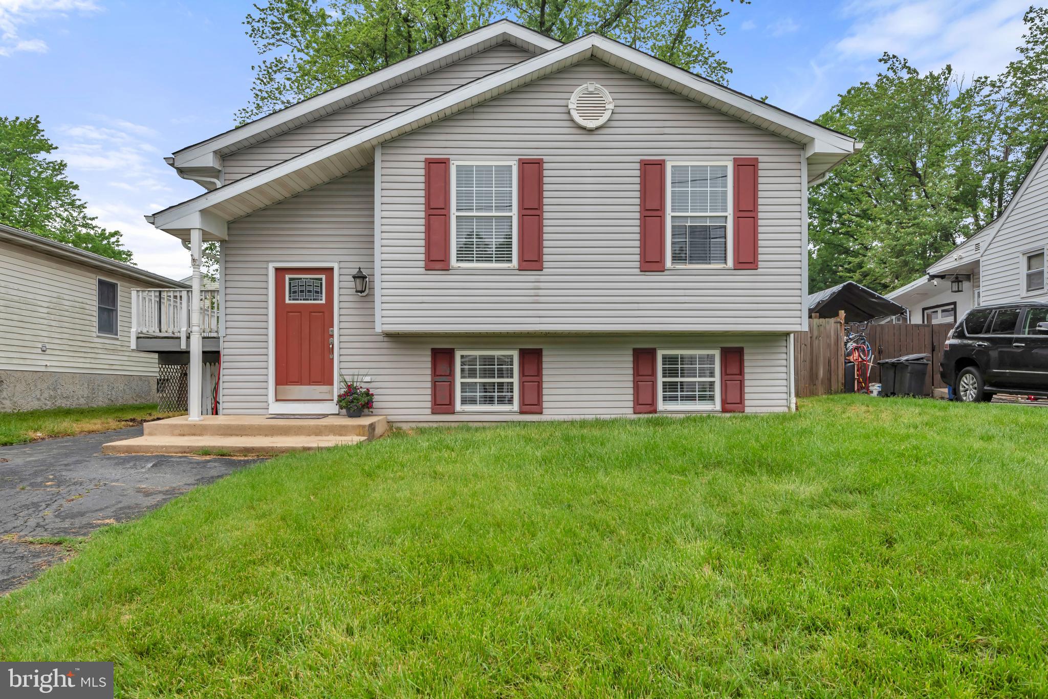 1223 Kendrick Road Baltimore, MD 21237 - Photo 1 of 36 a front view of a house with a garden and yard