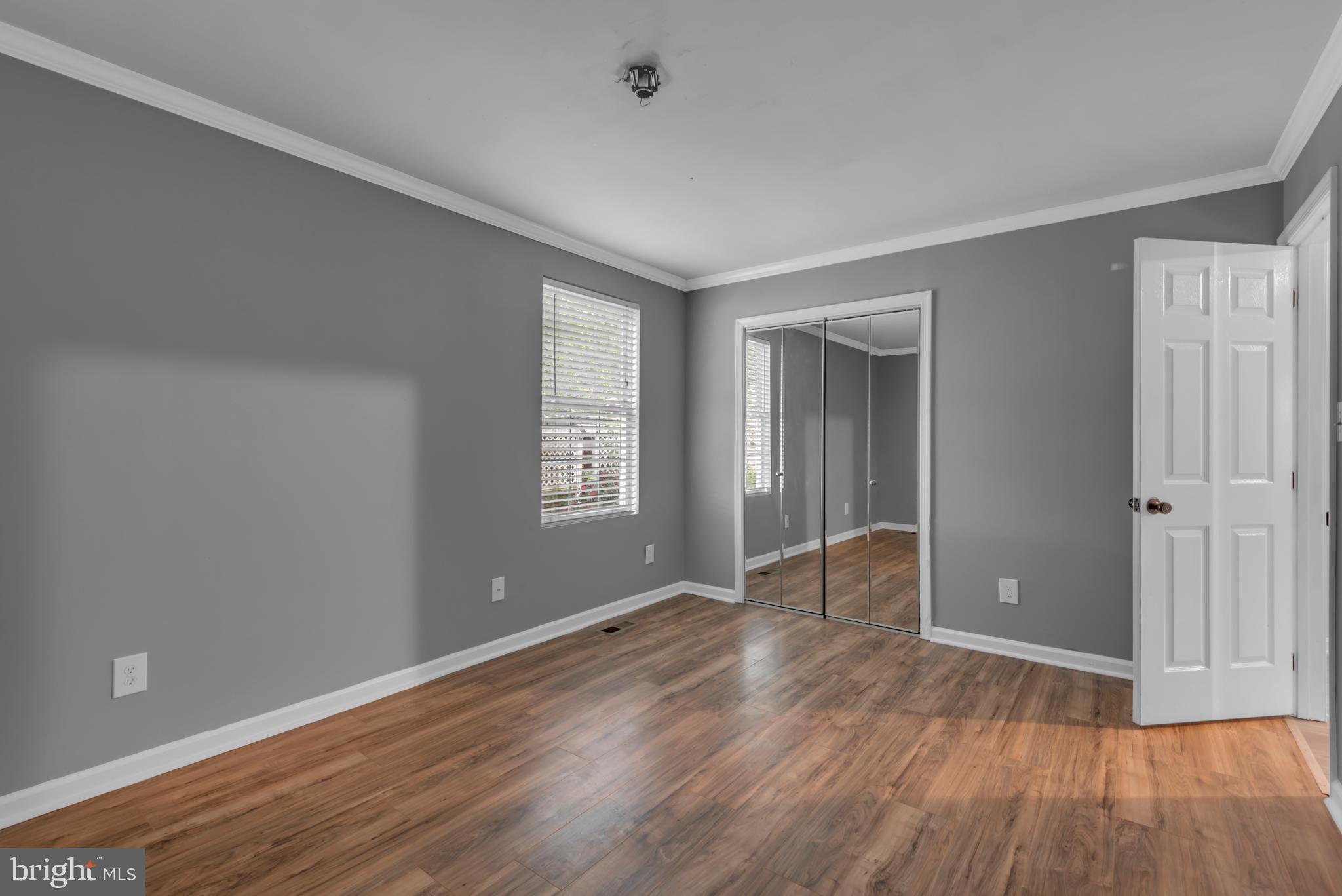 1223 Kendrick Road Baltimore, MD 21237 - Photo 18 of 36 wooden floor in an empty room with a window