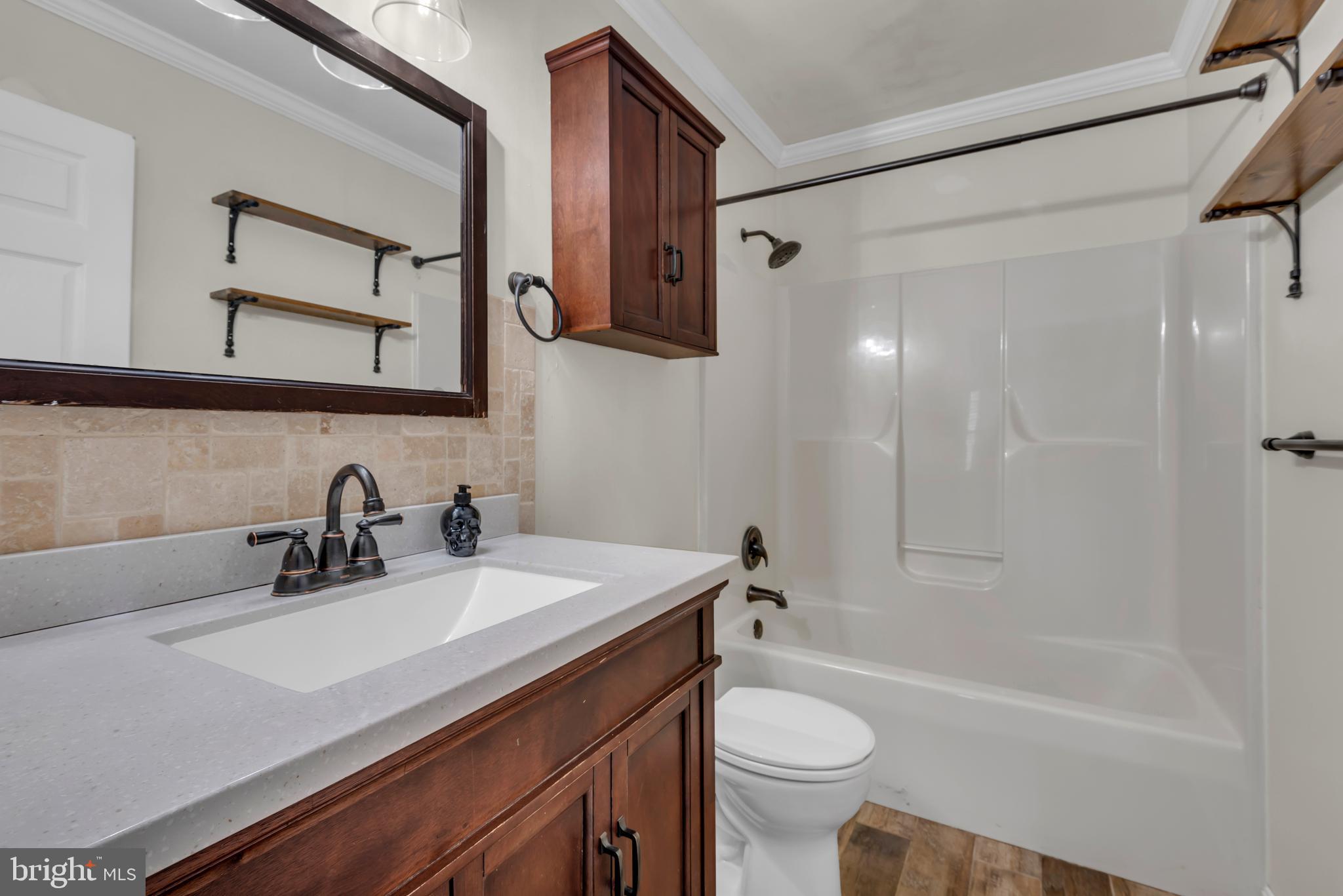 1223 Kendrick Road Baltimore, MD 21237 - Photo 20 of 36 a bathroom with a sink a toilet and a bathtub