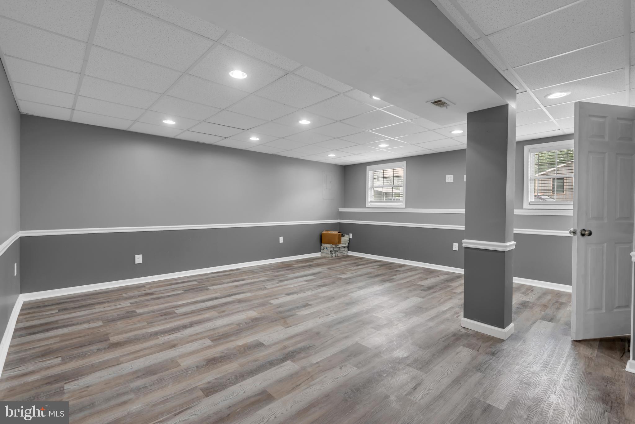 1223 Kendrick Road Baltimore, MD 21237 - Photo 26 of 36 a view of an empty room with wooden floor and windows