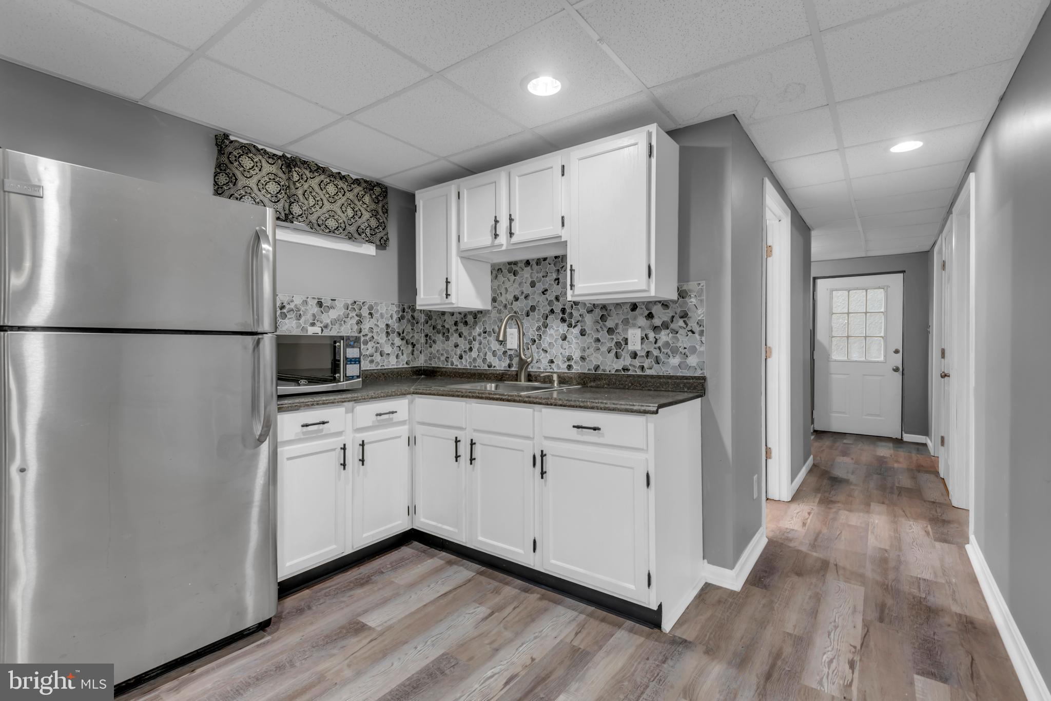 1223 Kendrick Road Baltimore, MD 21237 - Photo 27 of 36 a kitchen with stainless steel appliances granite countertop a refrigerator and a sink
