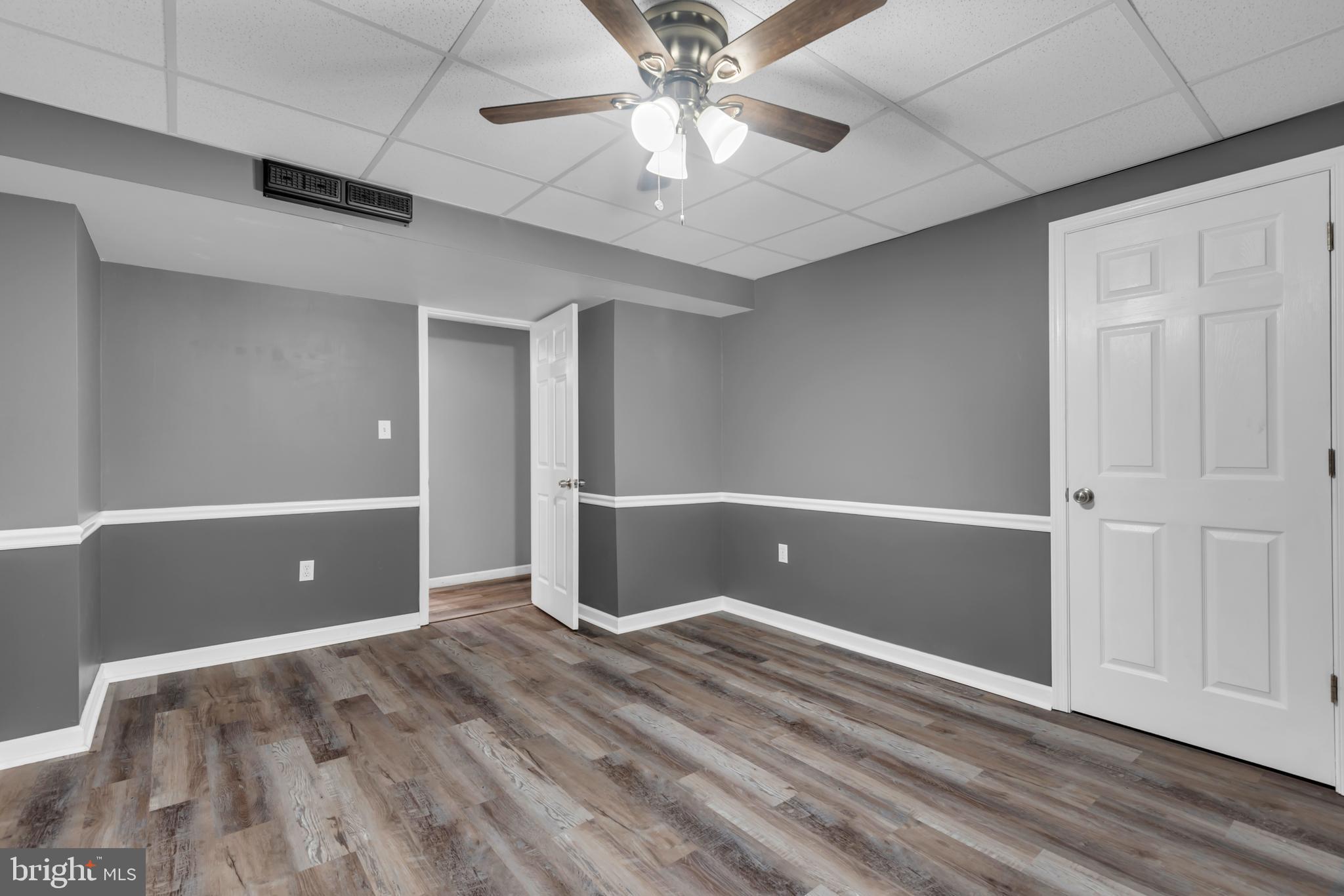 1223 Kendrick Road Baltimore, MD 21237 - Photo 30 of 36 a view of an empty room with window and wooden floor
