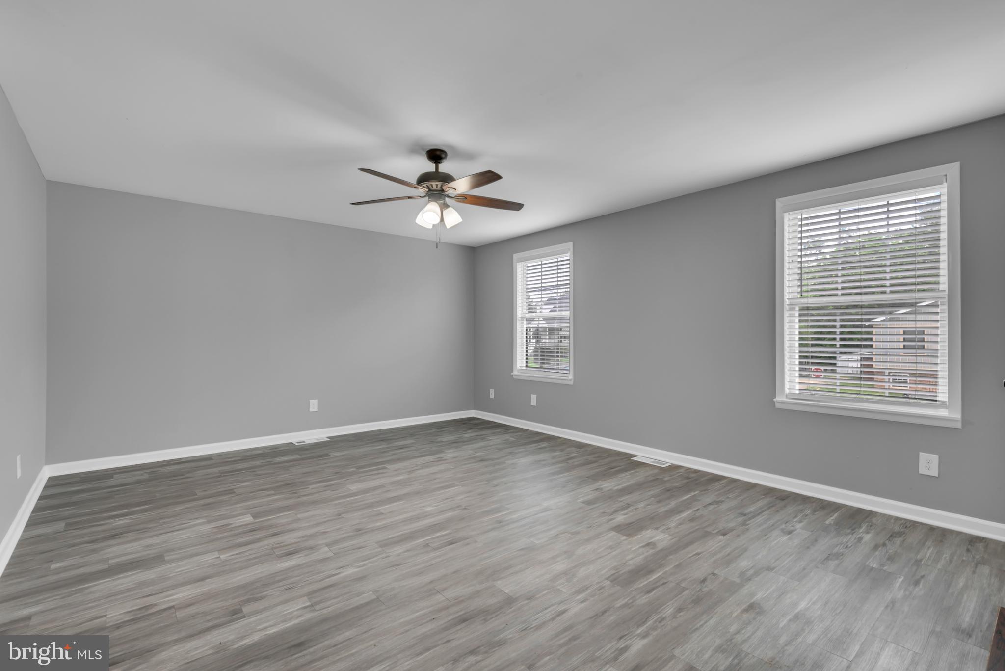 1223 Kendrick Road Baltimore, MD 21237 - Photo 3 of 36 a view of an empty room with a window and wooden floor