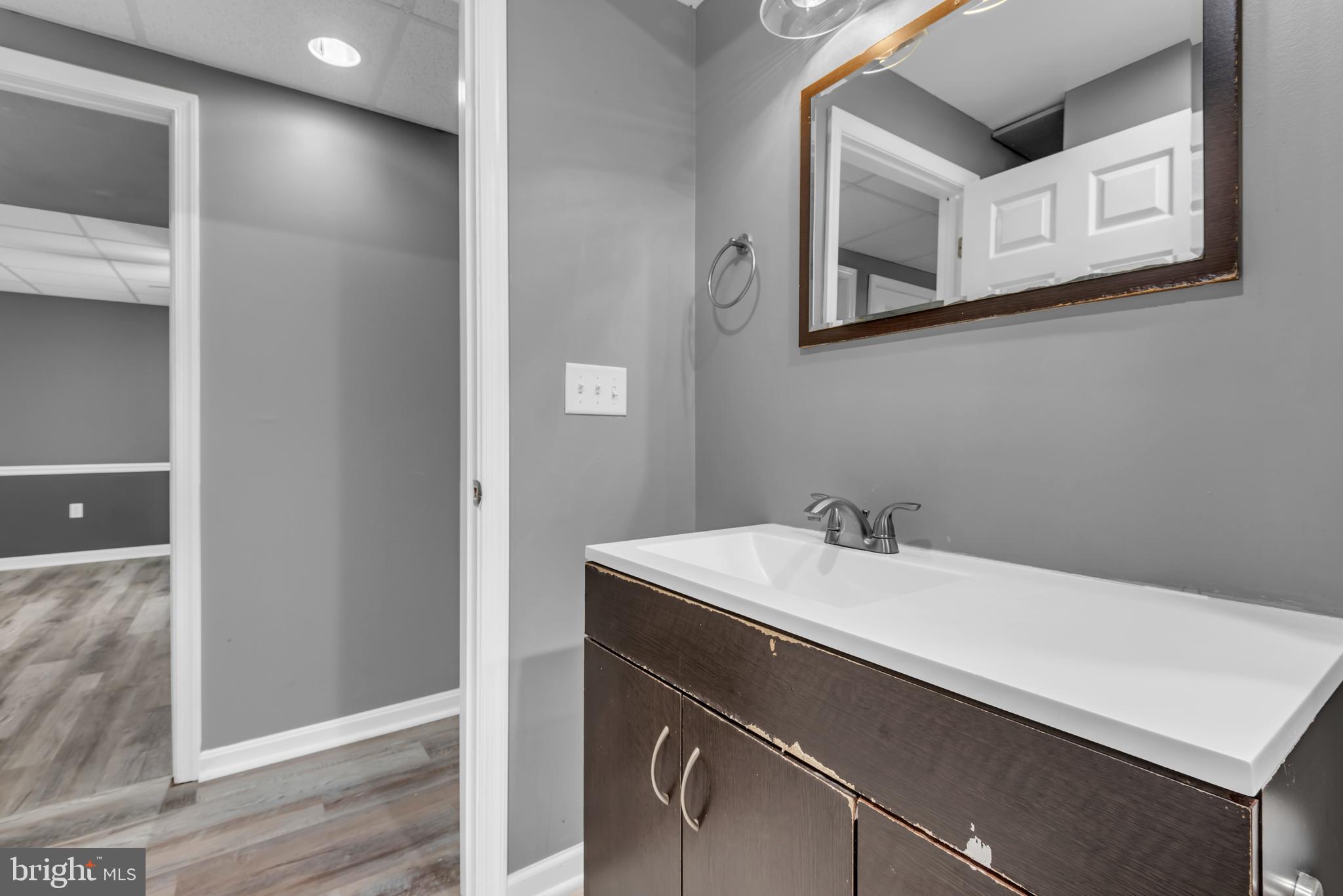 1223 Kendrick Road Baltimore, MD 21237 - Photo 32 of 36 a bathroom with a sink and a mirror