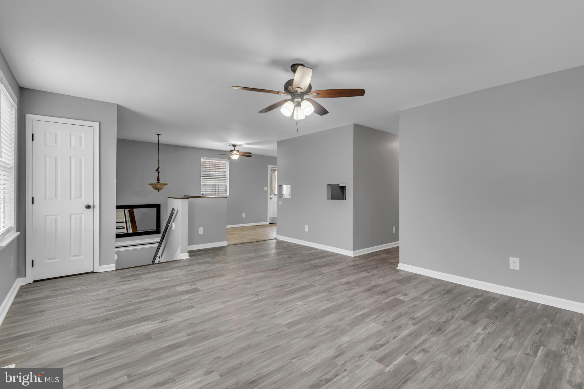 1223 Kendrick Road Baltimore, MD 21237 - Photo 5 of 36 a view of empty room with wooden floor and ceiling fan