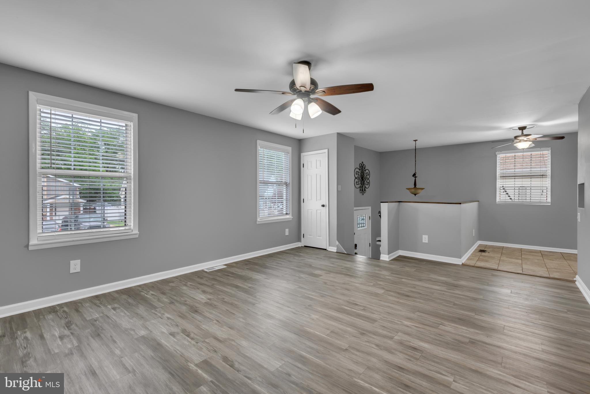 1223 Kendrick Road Baltimore, MD 21237 - Photo 6 of 36 a view of an empty room with window and wooden floor