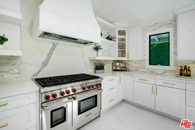 a kitchen with granite countertop cabinets and white stove top oven