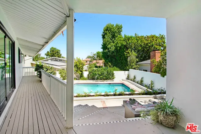 a view of a patio with couches and potted plants