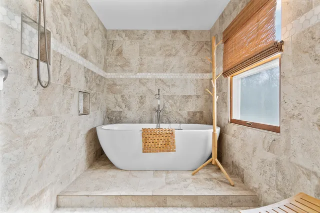 a bathroom with a granite countertop sink a mirror and a shower