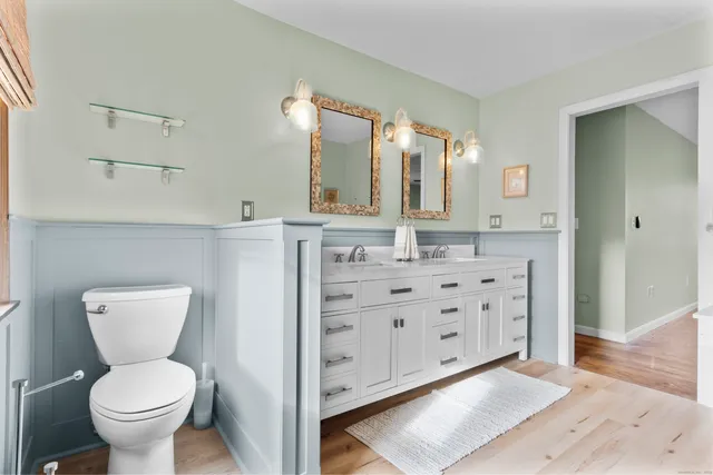 a bathroom with a sink mirror and vanity