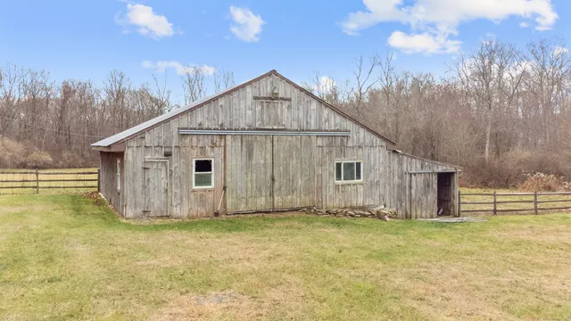 a view of a house with a yard and garage