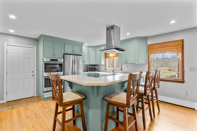a view of an empty room with a window and a ceiling fan