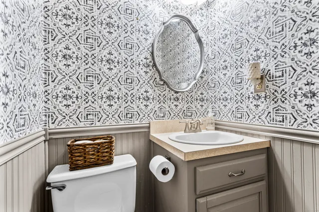 a white bath tub sitting in a bathroom next to a window