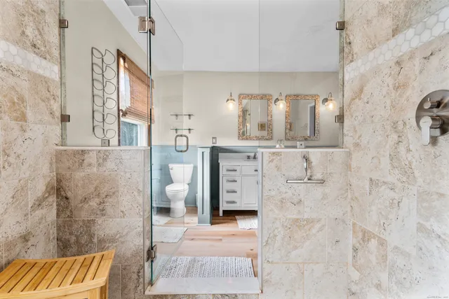 a bathroom with a toilet sink and mirror