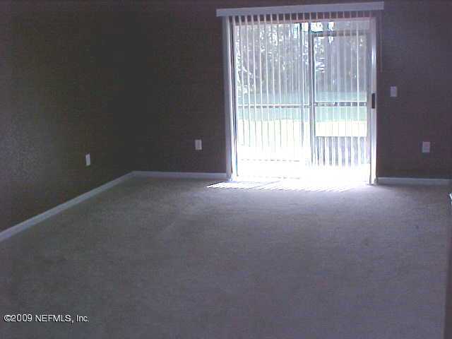 10200 Belle Rive Boulevard, Unit 4702 Jacksonville, FL 32256 - Photo 2 of 10 a view of an empty room with a balcony