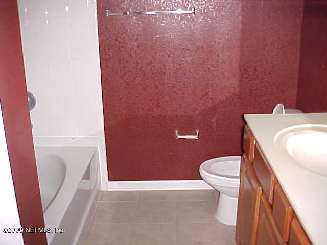 10200 Belle Rive Boulevard, Unit 4702 Jacksonville, FL 32256 - Photo 7 of 10 a white toilet sitting next to a sink