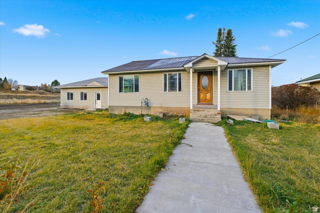 165 Main Street Georgetown, ID 83239 - Photo 2 of 50 View of front of home with a front lawn and a metal roof