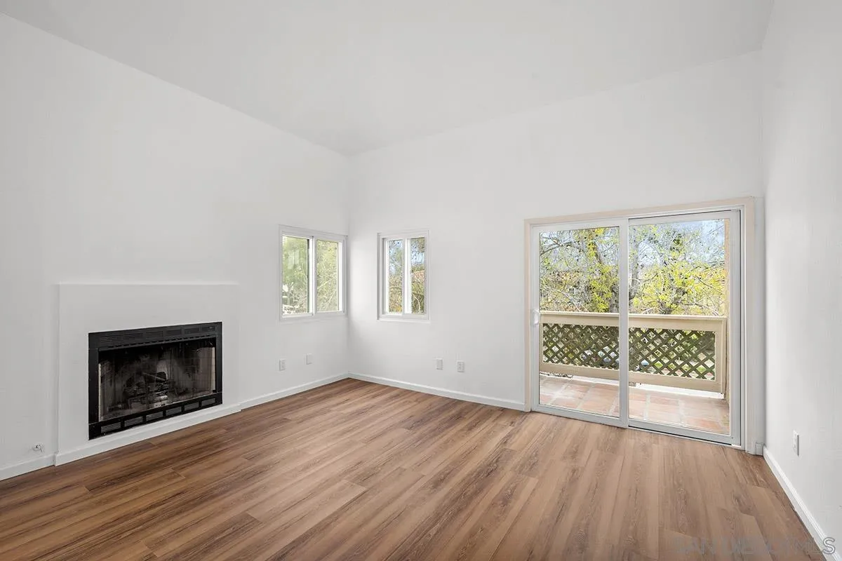 2742 A Street, Unit 202 San Diego, CA 92102 - Photo 7 of 22 an empty room with wooden floor fireplace and windows