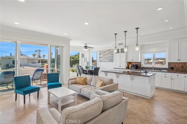 a living room with furniture and kitchen view