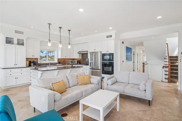 a living room with furniture a fireplace and a floor to ceiling window