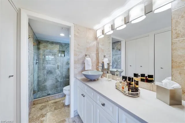 a bathroom with sink a toilet and shower