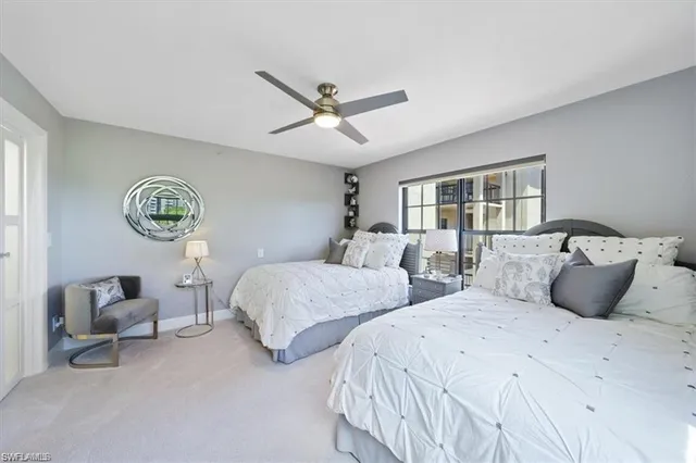 a bedroom with two beds and a large window