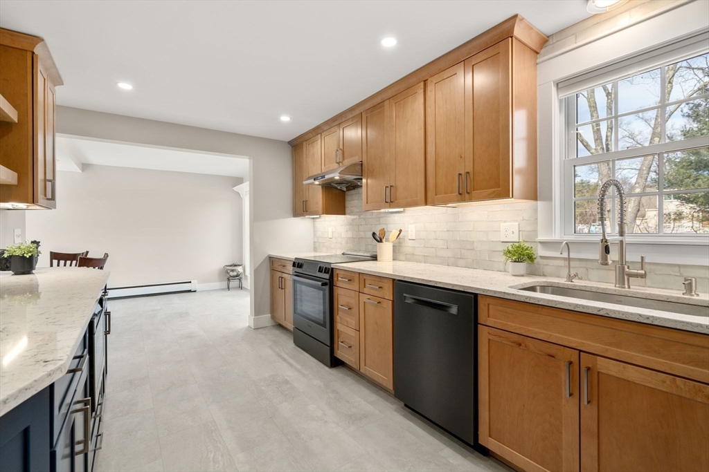 31 Sunset Drive Northborough, MA 01532 - Photo 8 of 33 a kitchen with a sink window and cabinets