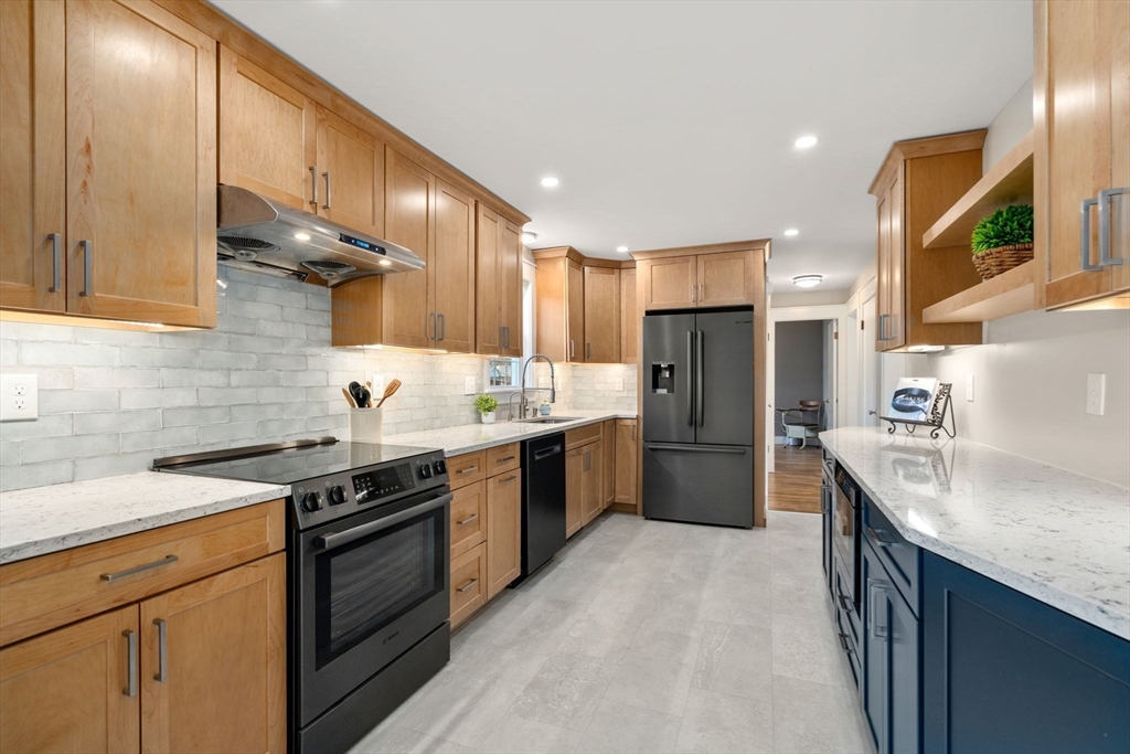 31 Sunset Drive Northborough, MA 01532 - Photo 10 of 33 a kitchen with stainless steel appliances granite countertop a sink a stove and a refrigerator