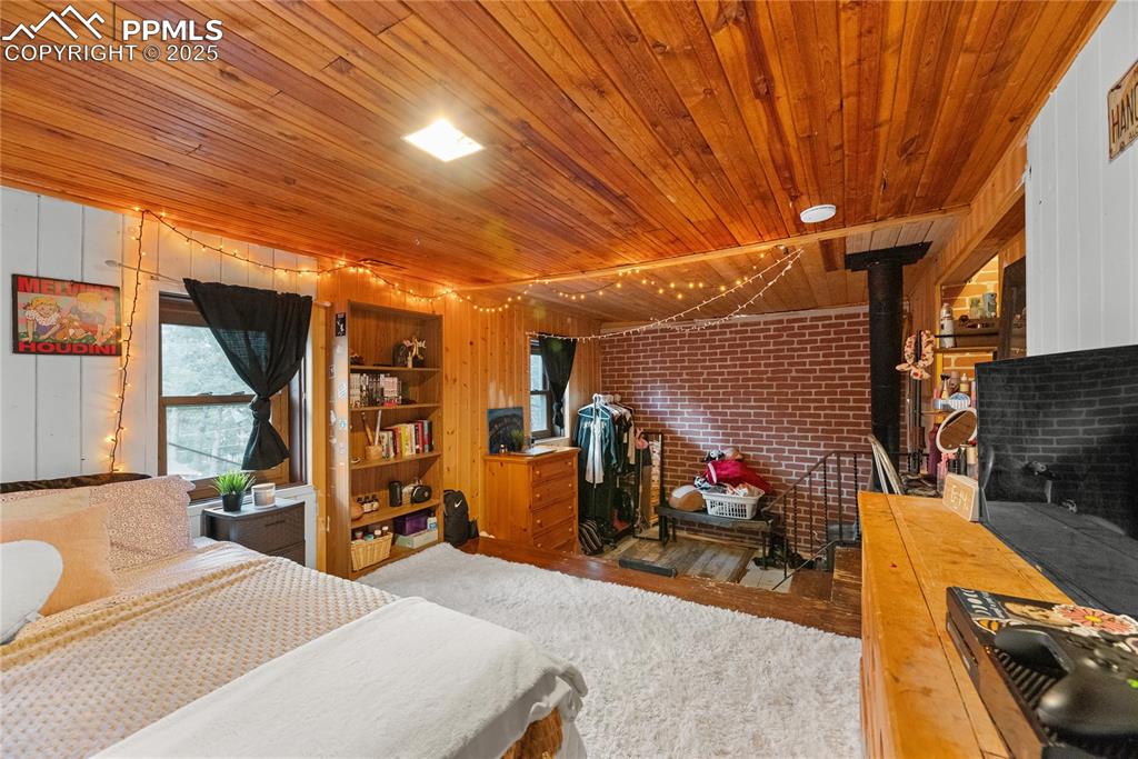 9270 Picabo Road Cascade, CO 80809 - Photo 26 of 31 a bedroom with furniture and a flat screen tv