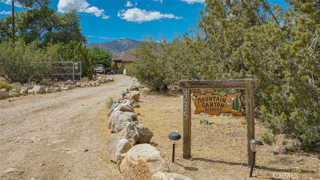 535 Cholla Road Pinon Hills, CA 92372 - Photo 1 of 1 a pathway of a house with a yard
