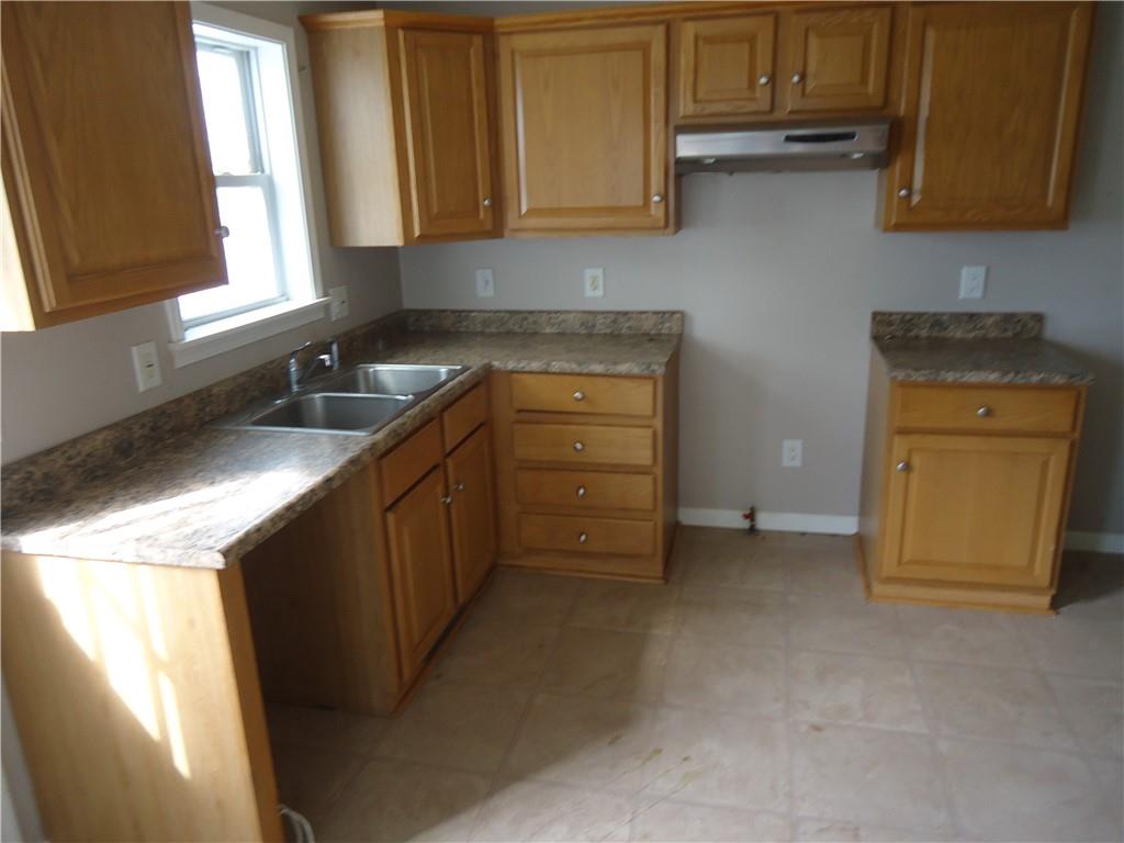 608 Reed Avenue Monessen, PA 15062 - Photo 2 of 20 a kitchen with granite countertop cabinets stainless steel appliances a sink and a window