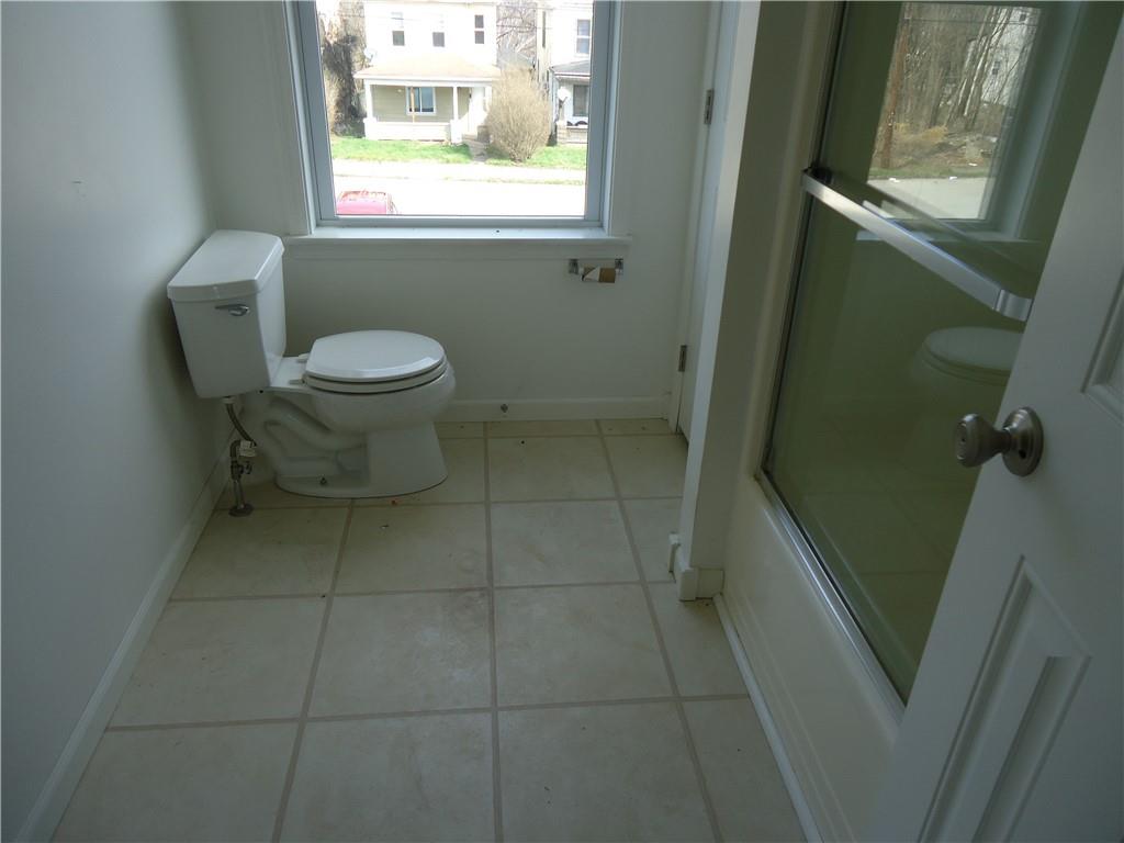 608 Reed Avenue Monessen, PA 15062 - Photo 7 of 20 a bathroom with a toilet a sink and a shower