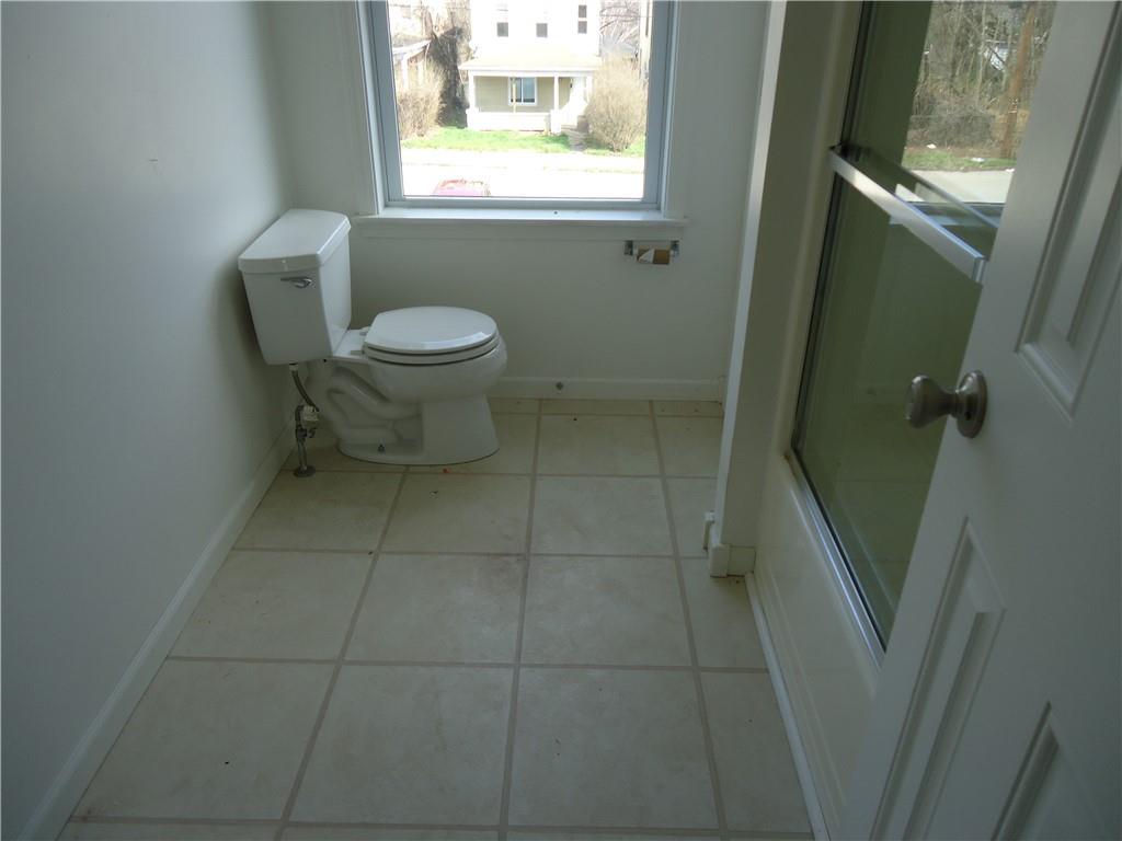 608 Reed Avenue Monessen, PA 15062 - Photo 8 of 20 a bathroom with a toilet a sink and a mirror