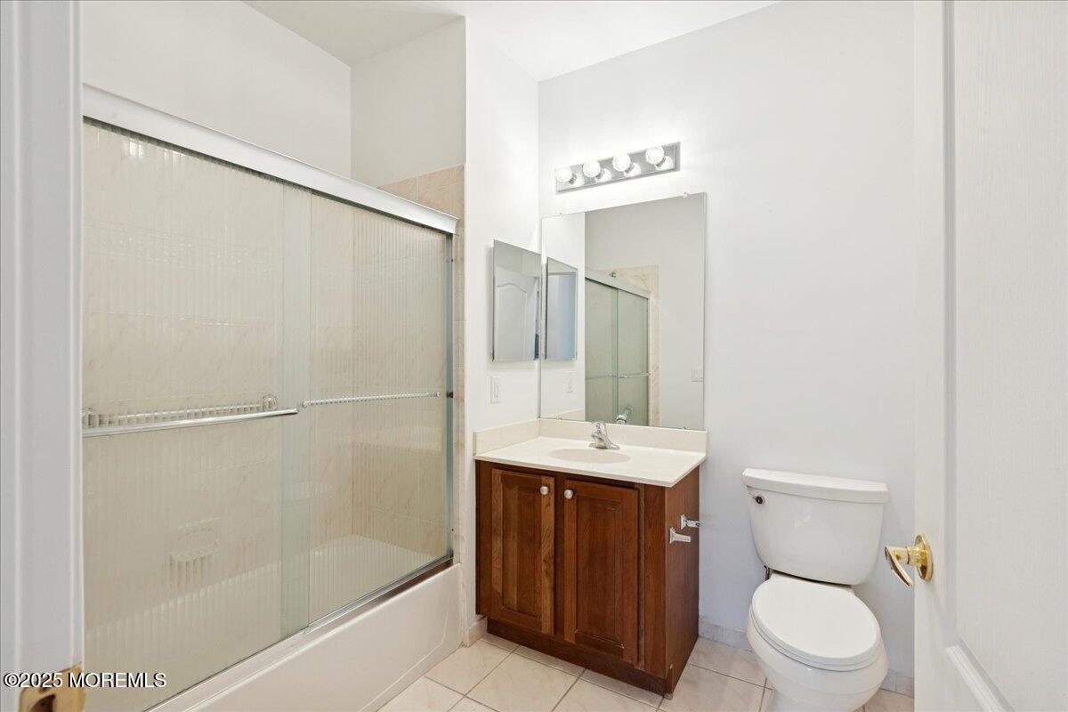 7317 Falston Circle, Unit 7317 Old Bridge, NJ 08857 - Photo 20 of 24 a bathroom with a sink a toilet a mirror and shower
