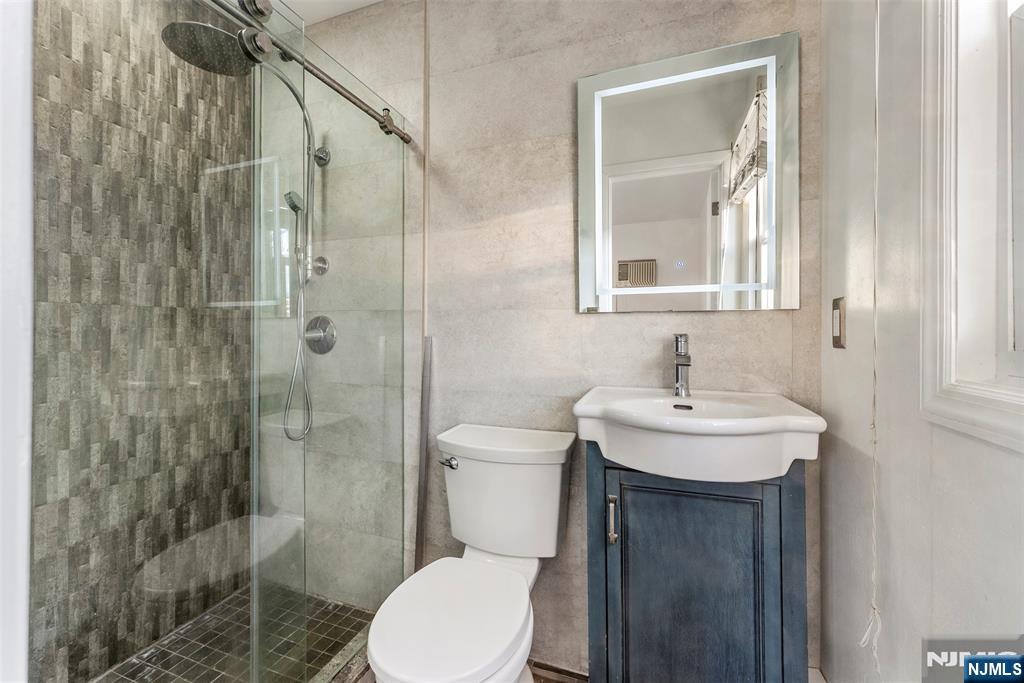 1 Dunn Road West Orange, NJ 07052 - Photo 13 of 20 a bathroom with a sink a toilet and shower