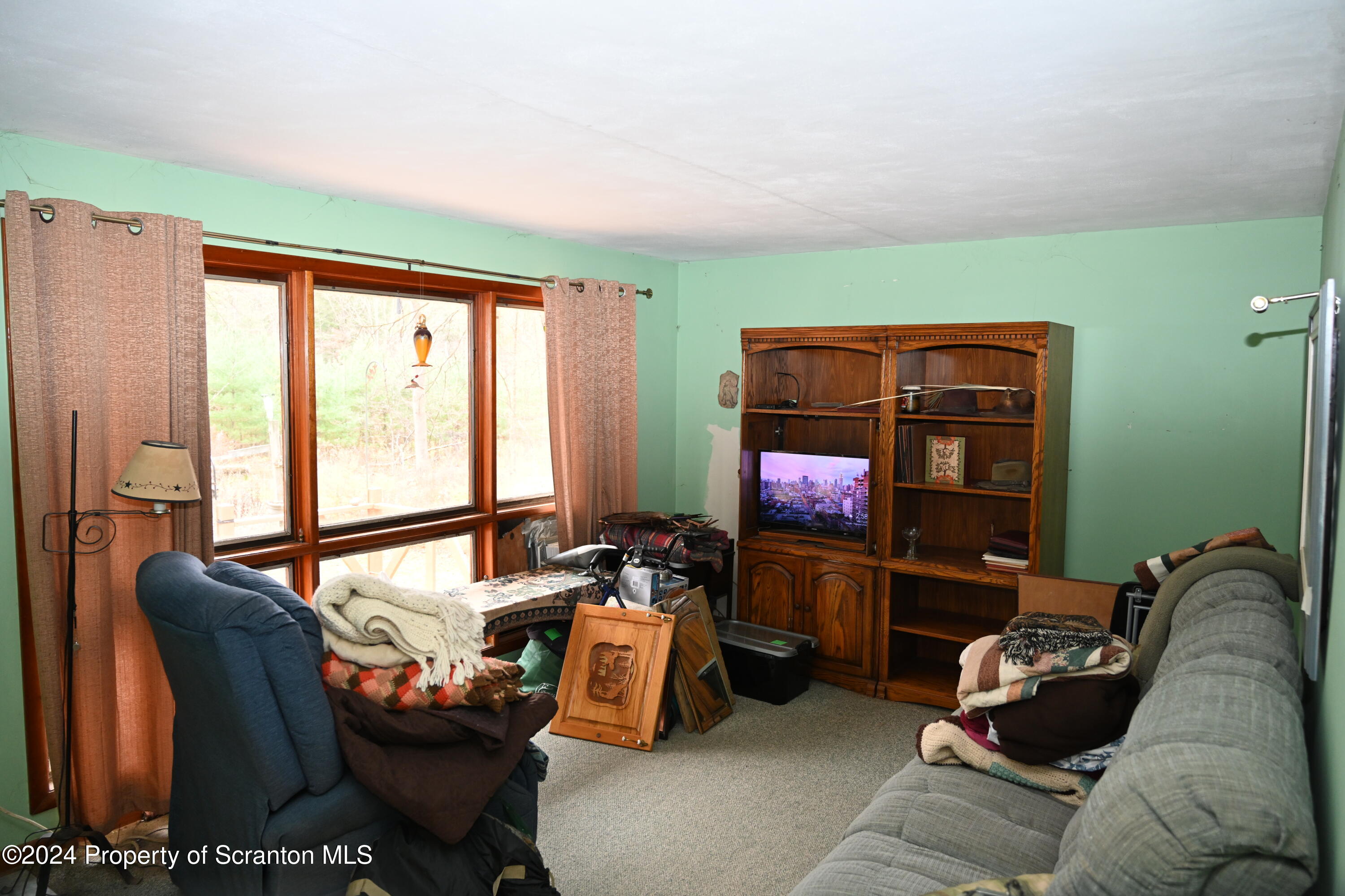 35 Pine Ayre Road Hallstead, PA 18822 - Photo 7 of 24 a living room with furniture a flat screen tv and a window