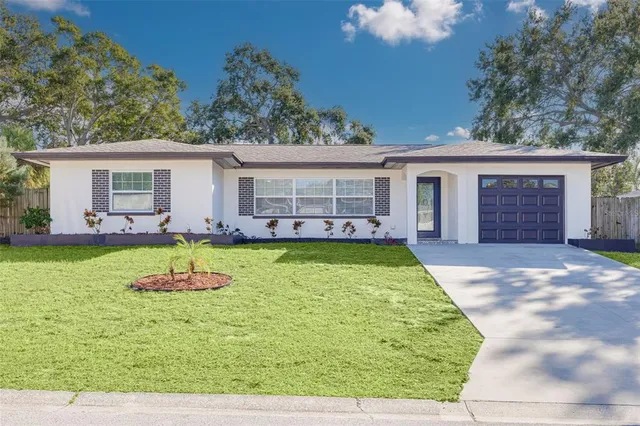 a view of a house with swimming pool and a yard