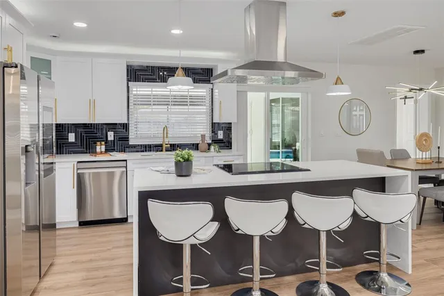 a kitchen with a table chairs stove and cabinets