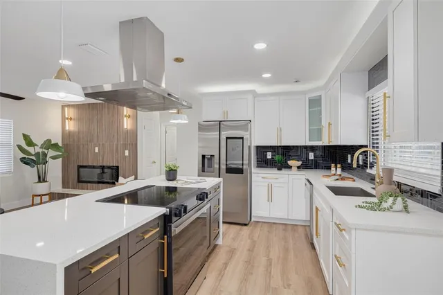 a kitchen with a sink stove and cabinets