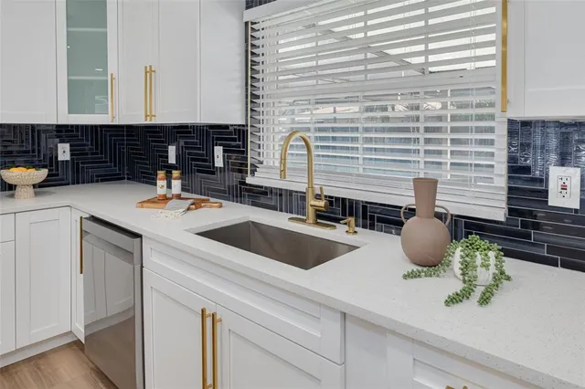 a kitchen with a sink and cabinets