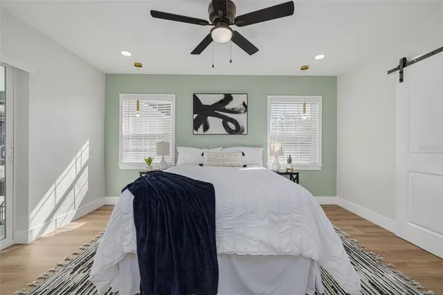 a bedroom with a bed and a chandelier