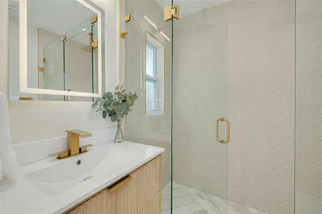 a bathroom with a sink a mirror and shower