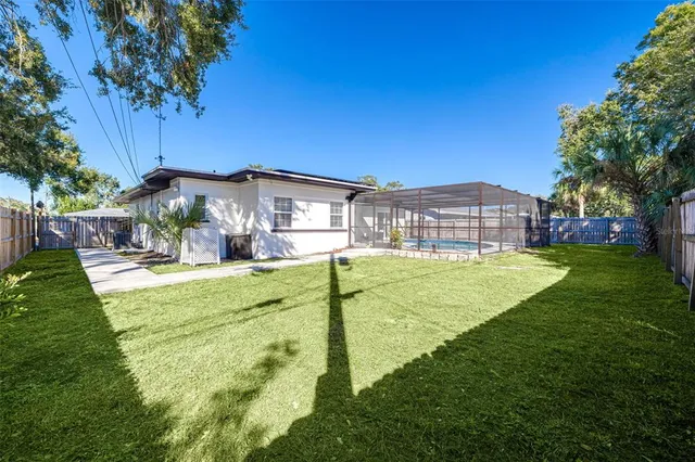 a view of a house with a backyard