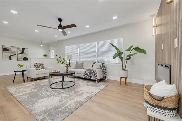 a living room with furniture and a potted plant