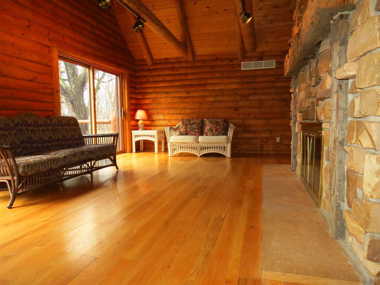 12444 Quail Ridge Close Rockton, IL 61072 - Photo 13 of 24 a living room with furniture a flat screen tv and a floor to ceiling window