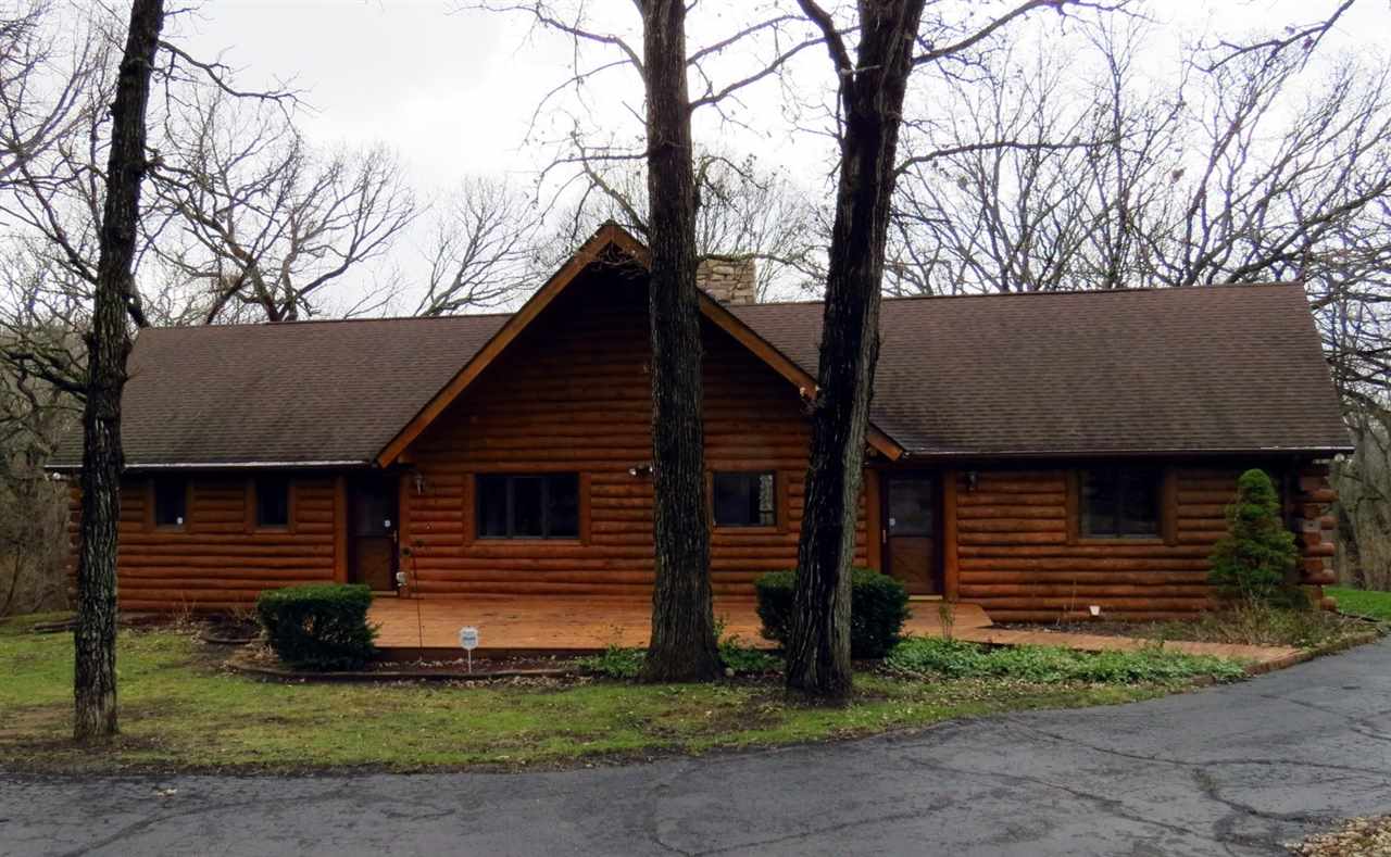 12444 Quail Ridge Close Rockton, IL 61072 - Photo 2 of 24 a front view of a house with garden